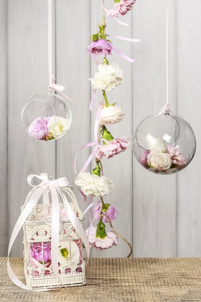 Vintage bird cage and glass balls with flowers inside — Stock fotografie
