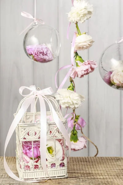 Vintage bird cage and glass balls with flowers inside — Stock fotografie