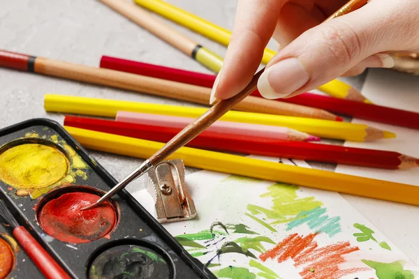 Watercolor paint box and colorful crayons — Stock Photo, Image