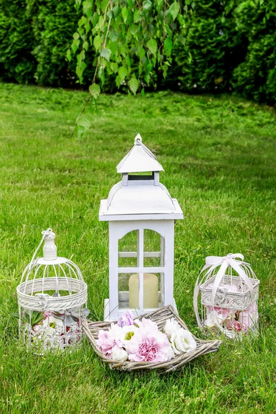 Garden party decorations: basket of flowers and vintage bird cag — Stockfoto