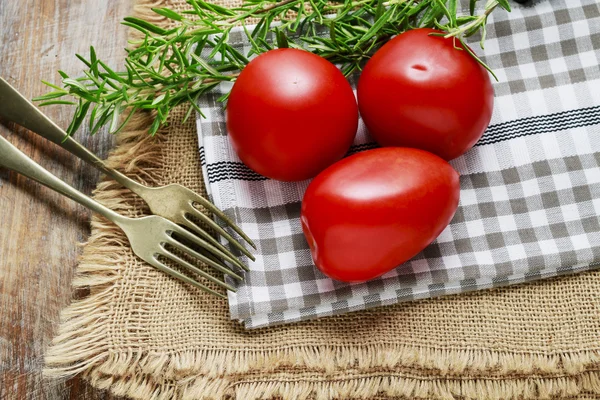 Red tomatoes and rosemary herb — Stock Photo, Image