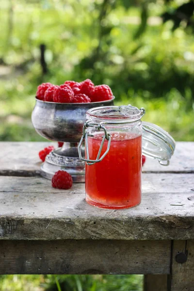 Jar of sweet jelly and raspberries in vintage silver goblet — Stock Photo, Image