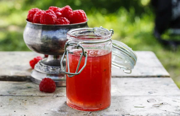 Jar of sweet jelly and raspberries in vintage silver goblet — Stock Photo, Image
