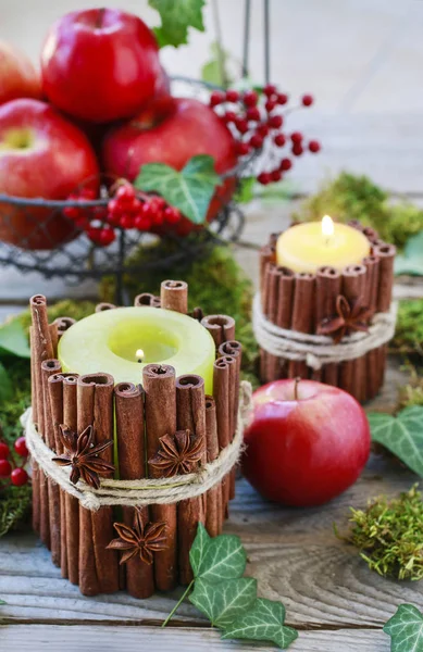 Candle decorated with cinnamon sticks — Stock Photo, Image