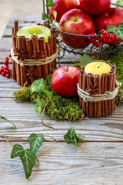 Candle decorated with cinnamon sticks — Stock Photo, Image