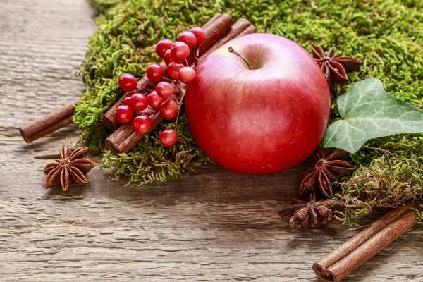 Traditional christmas decoration with red apple, cinnamon sticks — Stock Photo, Image