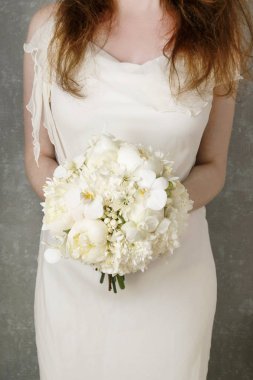 Woman in a white dress holding white bouquet with peonies, carna clipart