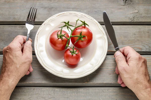 Conceptual image of man eating red tomatoes — Stock Photo, Image