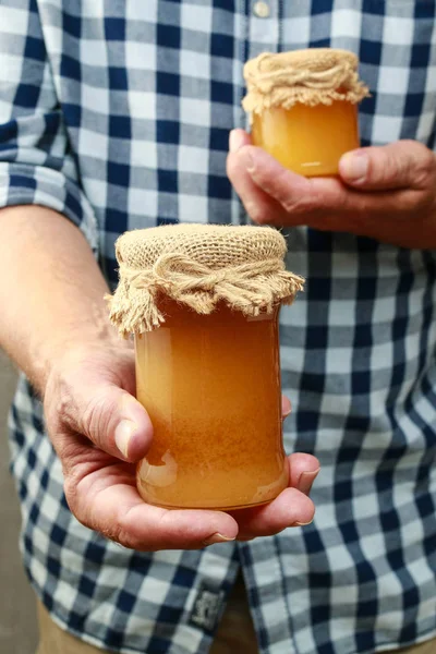 Man holding jars of honey — Stock Photo, Image