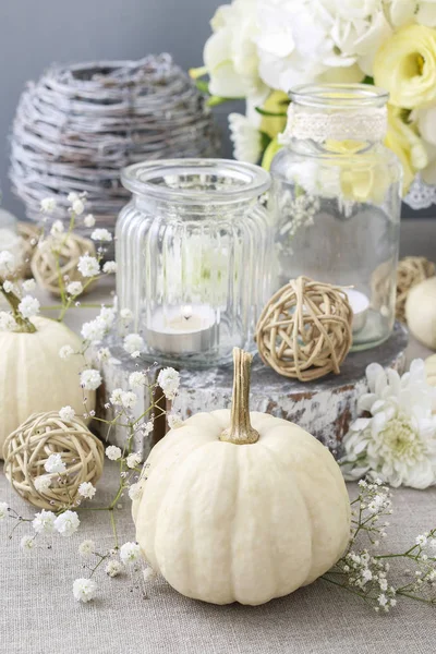 Floral decoration with white pumpkins called baby boo
