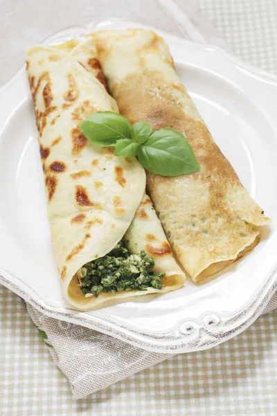 Mediterranean cuisine: crepes stuffed with cheese and spinach — Stock Photo, Image