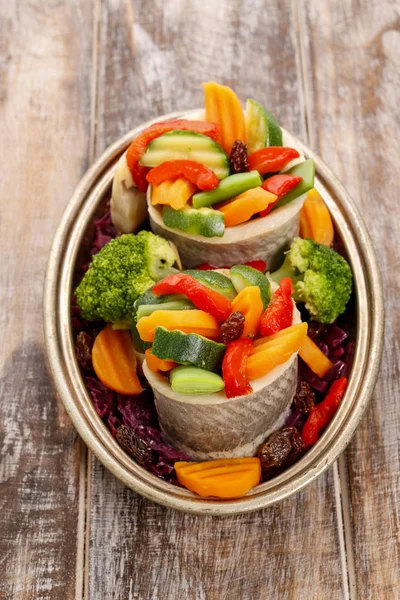 Pickled herring rolls with vegetables. — Stock Photo, Image