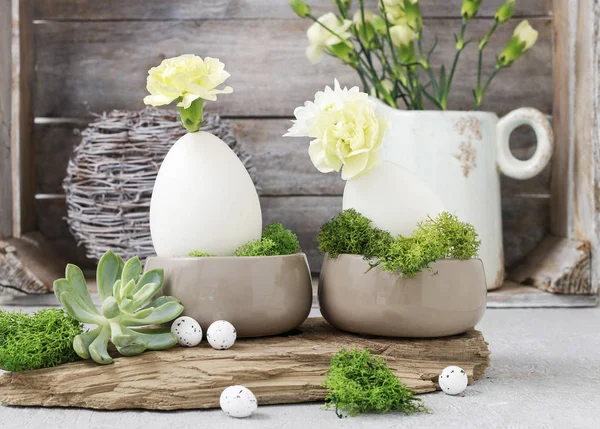 Floral arrangement with goose egg, carnations, chrysanthemum and