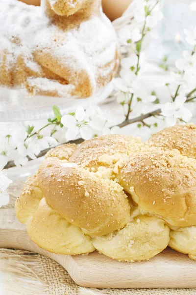 Loaf of sweet bread and cherry blossom twig Stock Photo