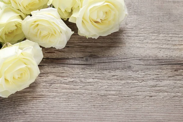 Yellow roses on wooden background — Stock Photo, Image