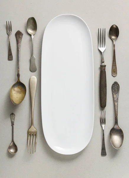 Top view of empty plate and vintage cutlery — Stock Photo, Image