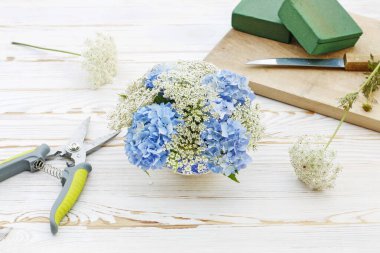 How to make floral arrangement with blue hortensia (hydrangea) a clipart