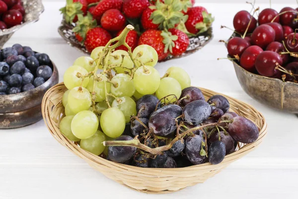 Diverse zomervruchten op een witte houten tafel. — Stockfoto