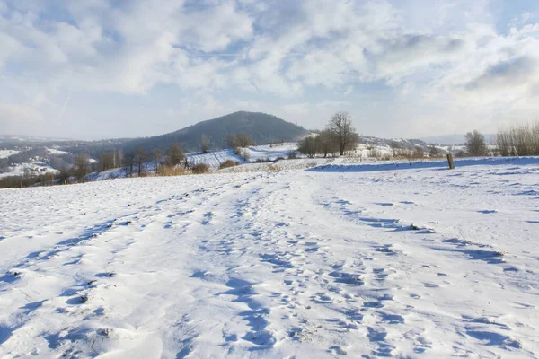 Fields and hills under the snow in winter.