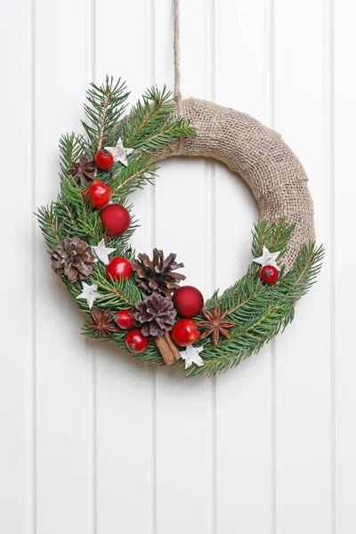 Woman shows how to make classic Christmas door wreath — Stock Photo, Image