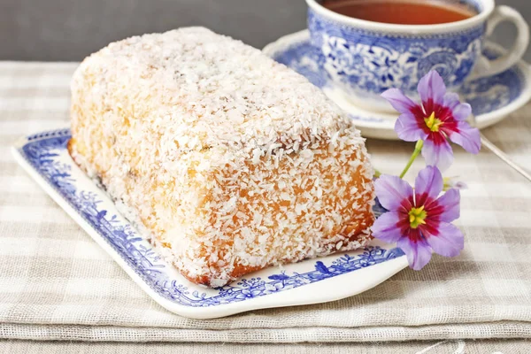 Coconut cake and cup of tea on the table. — Stock Photo, Image