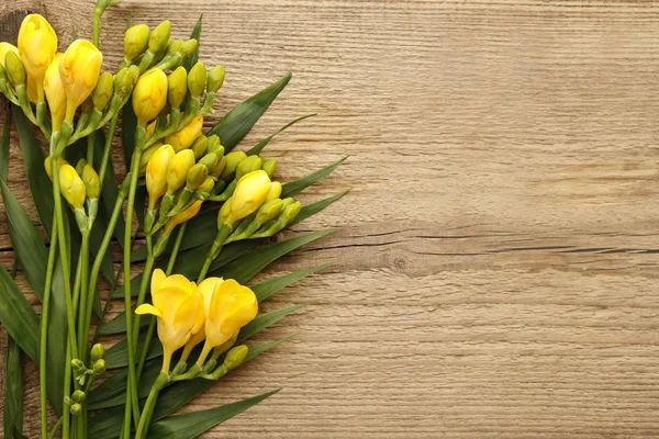 Amarelo freesia flor no fundo de madeira — Fotografia de Stock