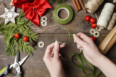 Woman shows how to make tiny thuja wreath