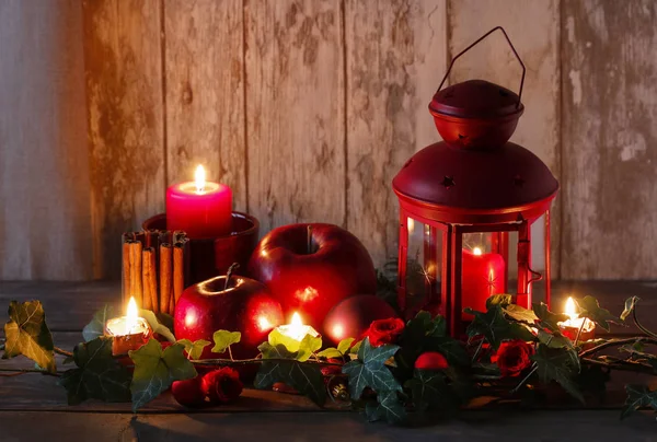 Christmas decoration with red lantern, candle, apples and ivy le — ストック写真