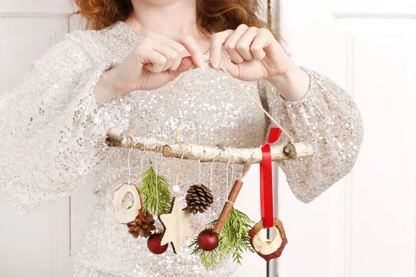 Woman holds a handmade, natural Christmas decoration. — Stock Photo, Image