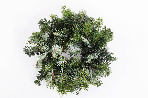 Christmas door wreath made of fir twigs, isolated on white background. Festive decor