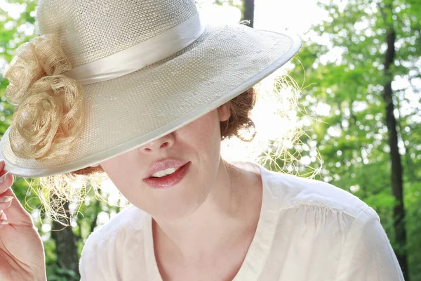 Young woman in victorian hat. Summer day