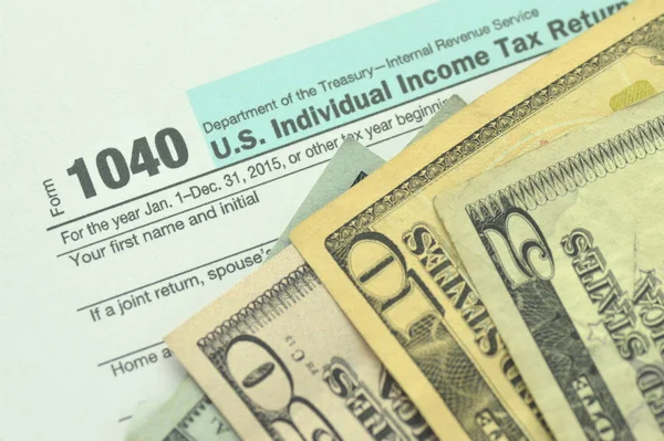 closeup of us tax form and us money