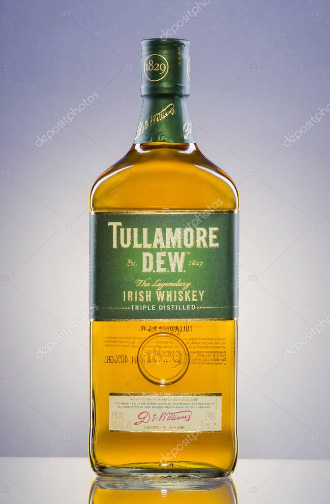 Tullamore Dew whiskey on gradient background. Tullamore Dew is blended Irish whiskey produced by William Grant and Sons since 1829.