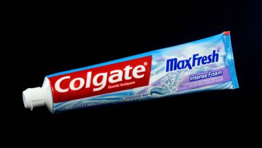 KWIDZYN, POLAND  FEBRUARY 3, 2018: Colgate toothpaste isolated on black background. Colgate is manufactured by American consumer-goods conglomerate Colgate-Palmolive. Colgate oral hygiene products were first sold by the company in 1873. clipart