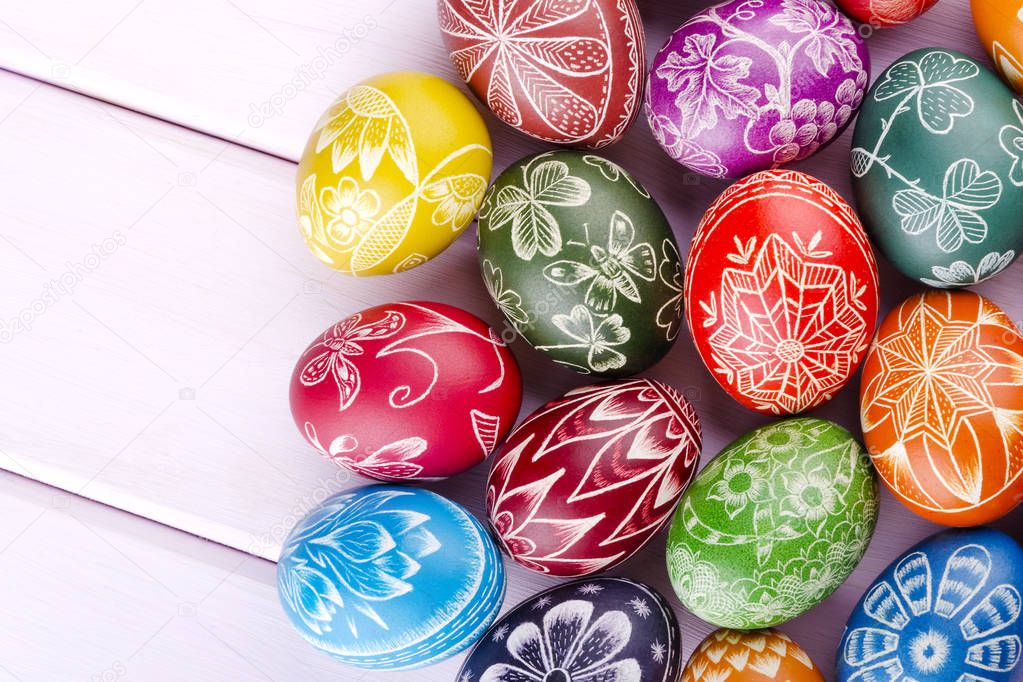 colorful scratched handmade Easter eggs on a wooden table