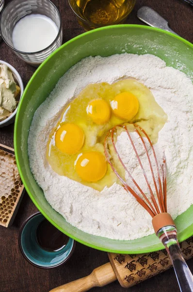 Ingredients and tools to make a cake - flour, butter, milk, eggs, honey