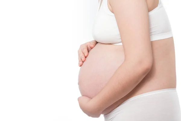 Asiatische schwangere Frau mit Schmerzen im Bauch auf weißem Hintergrund — Stockfoto