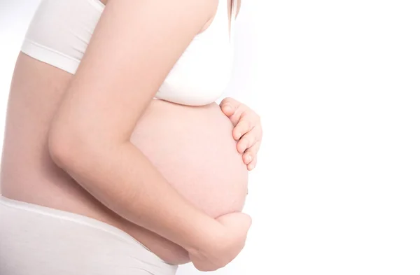 Asiática embarazada teniendo dolor en vientre en blanco fondo Fotos De Stock Sin Royalties Gratis