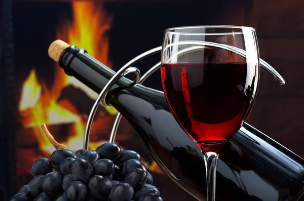 Red wine in glass and bottle of wine on the background of the fi — Stock Photo, Image