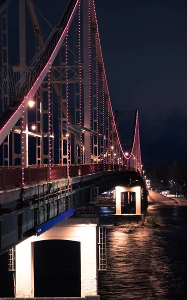 Pedestrian bridge at night with LED lights. Kyiv