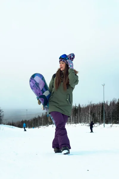 Aventura al deporte de invierno. Snowboarder chica senderismo en la montaña . —  Fotos de Stock