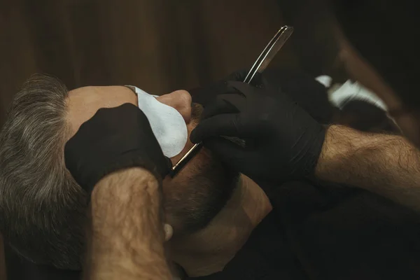 Details of trimming. Shaving a beard to a client in a barbershop — Stock Photo, Image