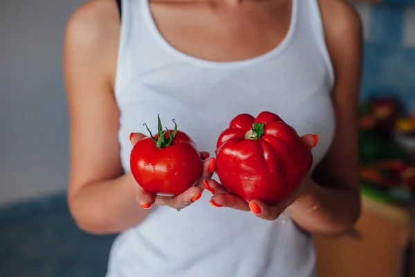 Woman holding red peppers — Stock Photo, Image