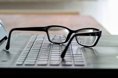 Glasses on the computer keyboard