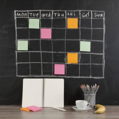 Grid timetable schedule with note paper on black chalkboard background. clipart