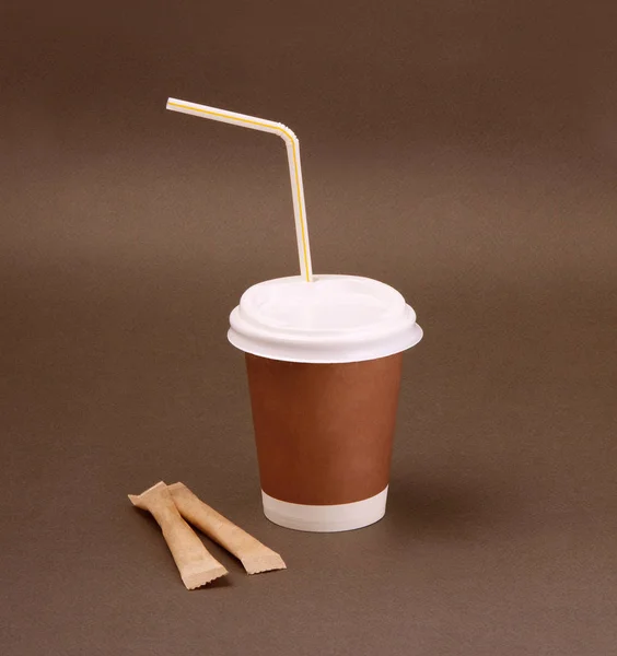 Clotheded take-out coffee with cup holder on brown background. — Stock Photo, Image