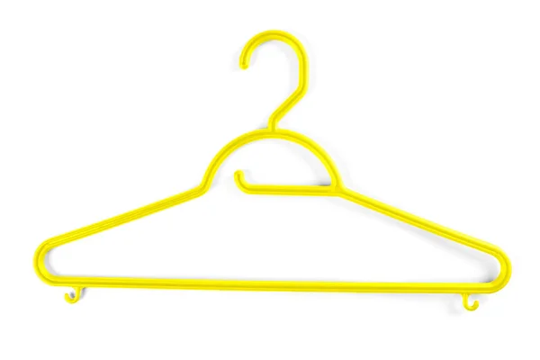 Cabide de plástico amarelo para roupas em um fundo branco . — Fotografia de Stock
