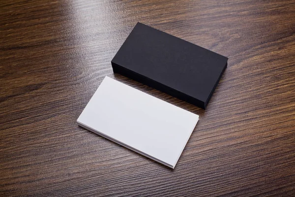 Mockup of white and black business cards at wooden background — Stock Photo, Image