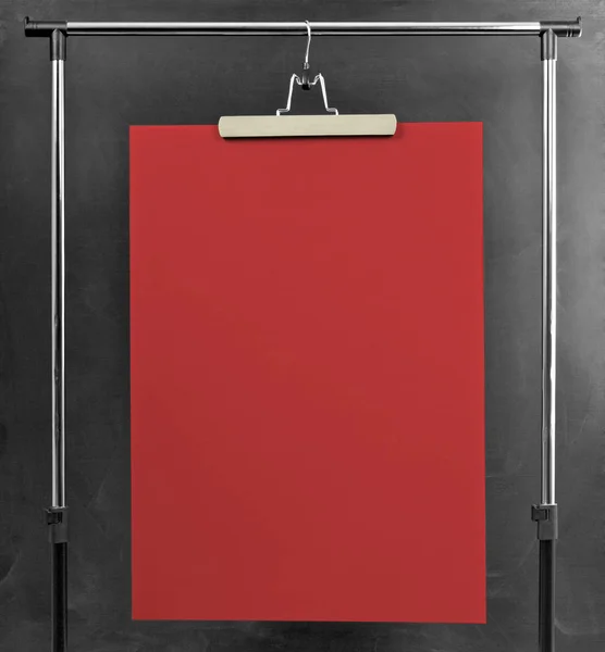 Red poster hanging at a clothes rack. — Stock Photo, Image