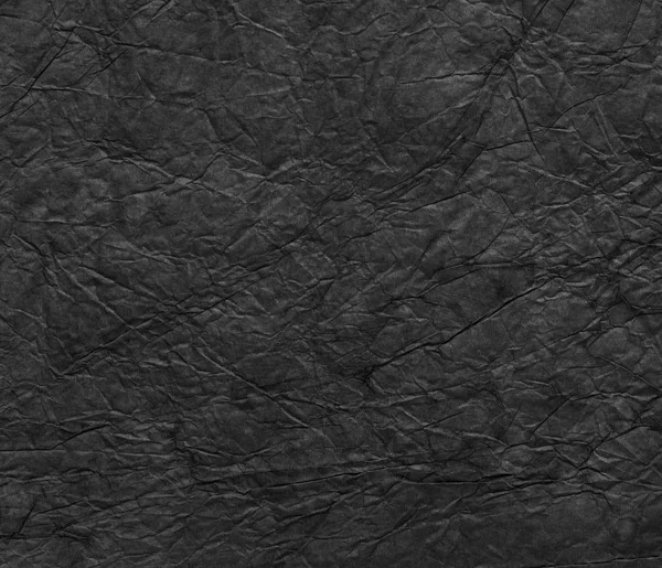 Černá zmačkaný papír textura pozadí. — Stock fotografie